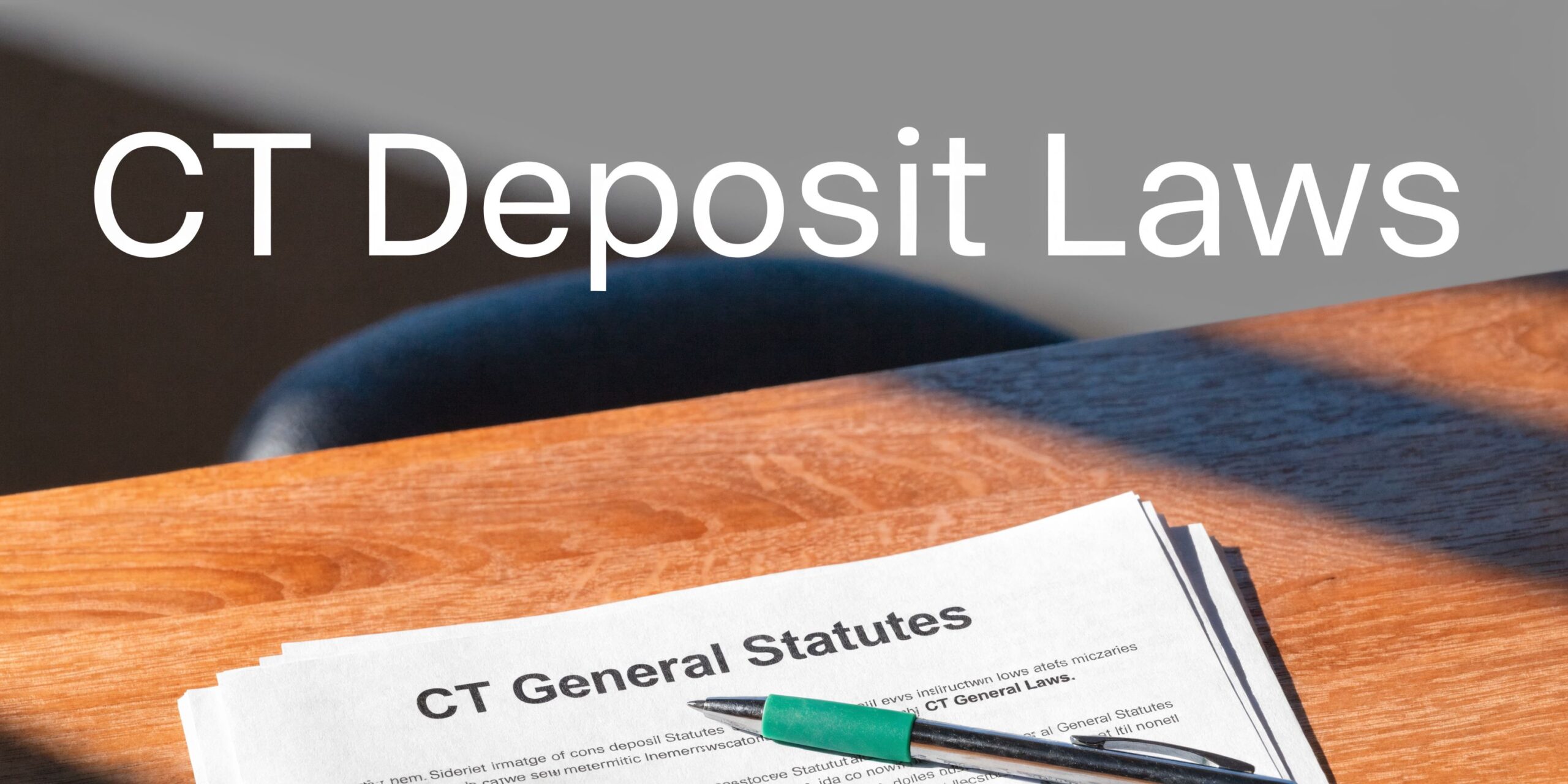 A green pen rests on top of a document titled CT General Statutes on a wooden table.