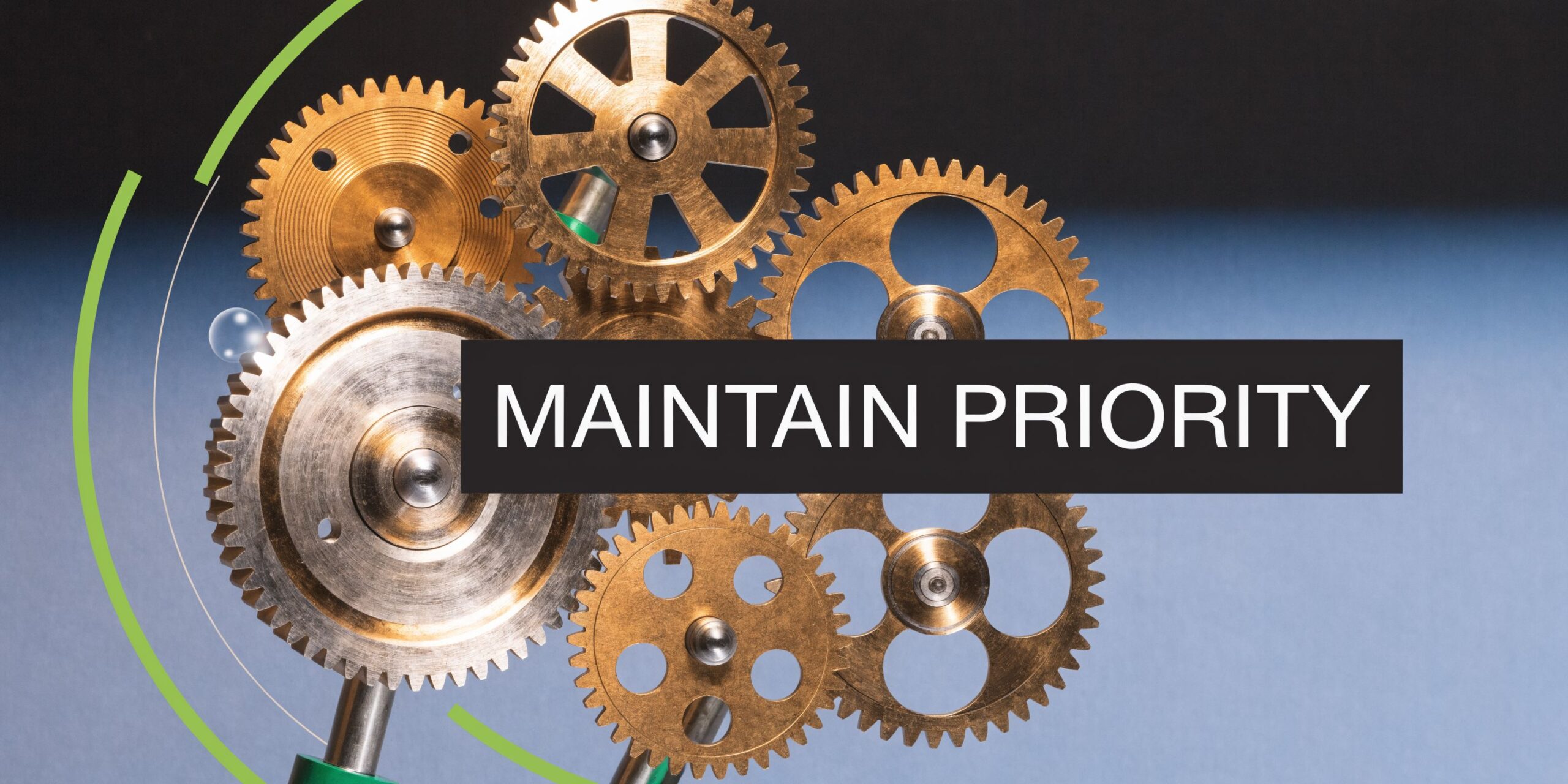 A close up of interconnected golden gears against a blue background representing mechanical efficiency and focus.