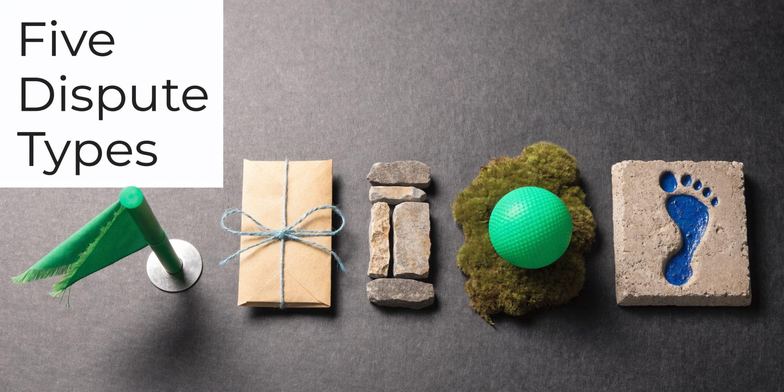 A conceptual photo showing symbols of land disputes including a flag, package, stones, moss, and footprint.