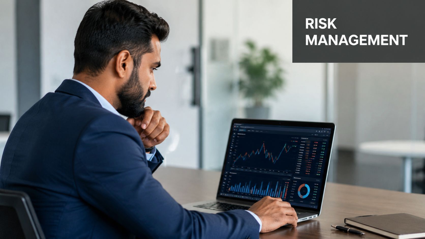 A professional man in a business suit analyzing financial data charts on a laptop screen.